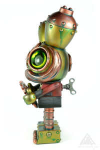 The Gear Sizer. A Mechtorian customised Spacemonkey toy from Dalek and Kidrobot.By Doktor A. Bruce Whistlecraft. 2022.Left.